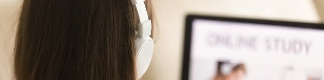 Woman on Computer With Headphones